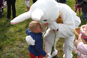 photo showing a person dresed in a bunny costume giving a child a hug.
