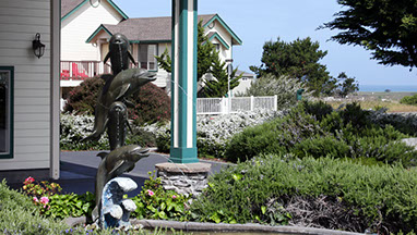 Fountain and shrubs at the front entrance of Emerald Dolphin Inn.