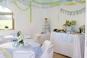 photo of a party decorated for a boy baby shower. colors of white blue and greens.