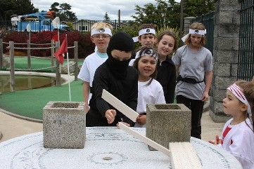 Children in line for a game at a ninja birthday party.