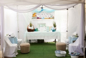 photo shows decorations at a very special baby shower. colors are done in white and blue.