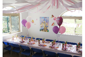 Party room setup with decorations for a childs party.